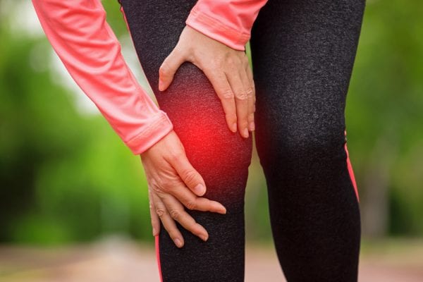 Woman experiencing pain from a torn ACL
